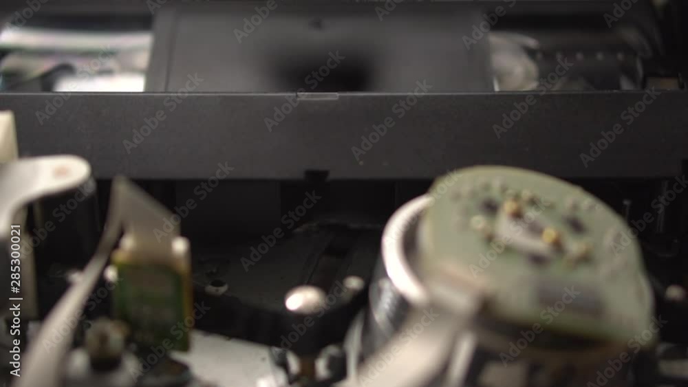 VCR cassette mechanism. Closeup. Rewind of videotape in the