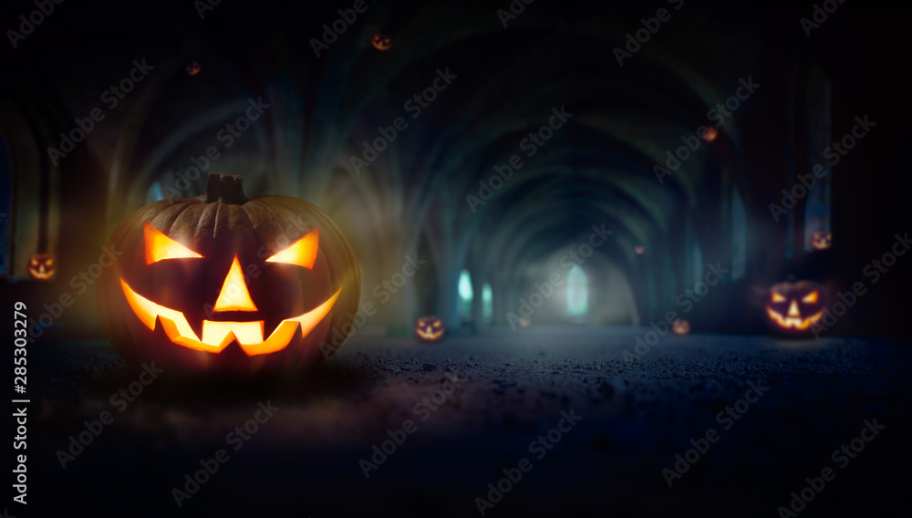 Naklejka premium Lots of Jack O' Lanterns in the dark blue spooky ruins of an old church, monastery