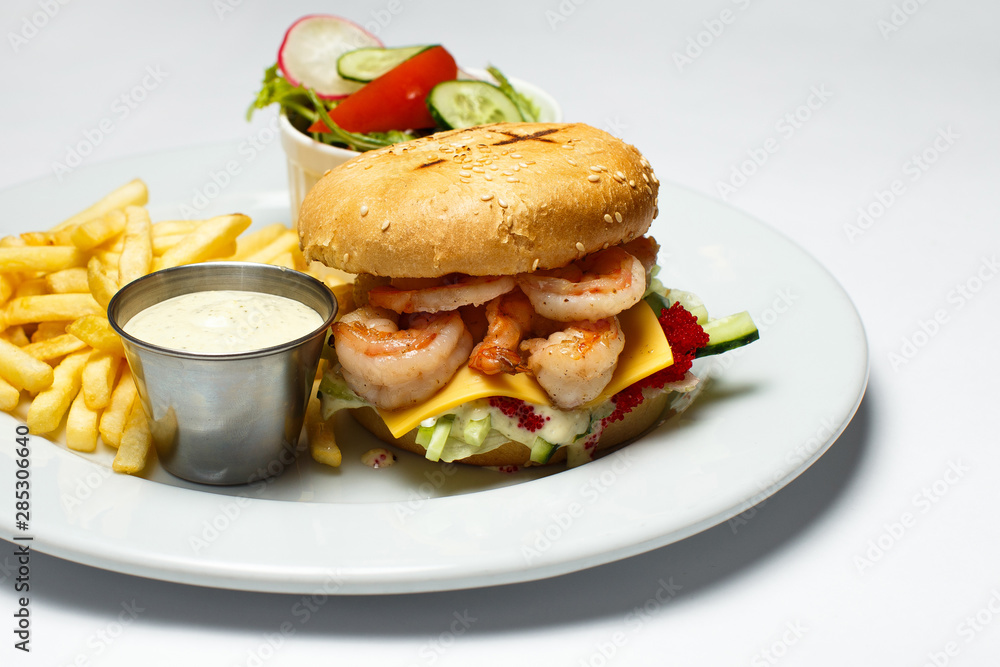 shrimp burger with caviar, vegetable salad and french fries, shrimp sauce shrimp burger with caviar, vegetable salad and french fries, shrimp sauce