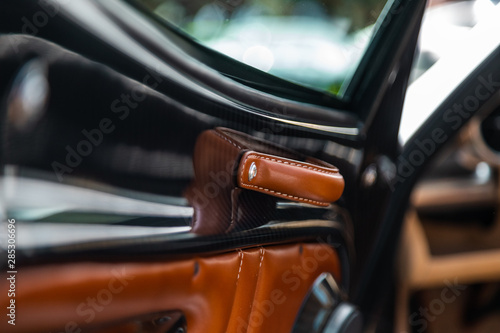 Orange and black Vintage old car exterior detail - handle