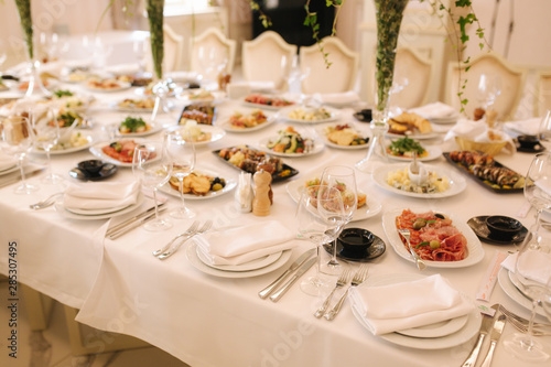 Table with mixed food. Banquet in restaurant, table setting. Differend meals for the guests. Fresh food © Aleksandr