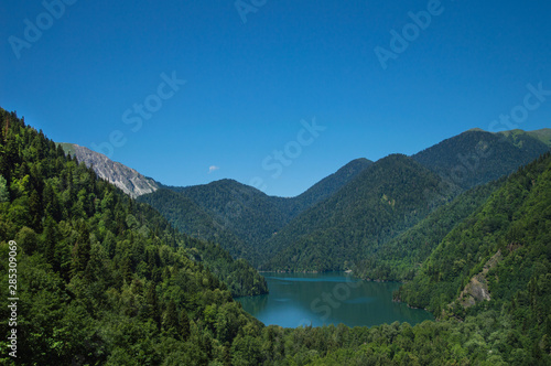 Panoramic view on mountain lake in front of mountain range.