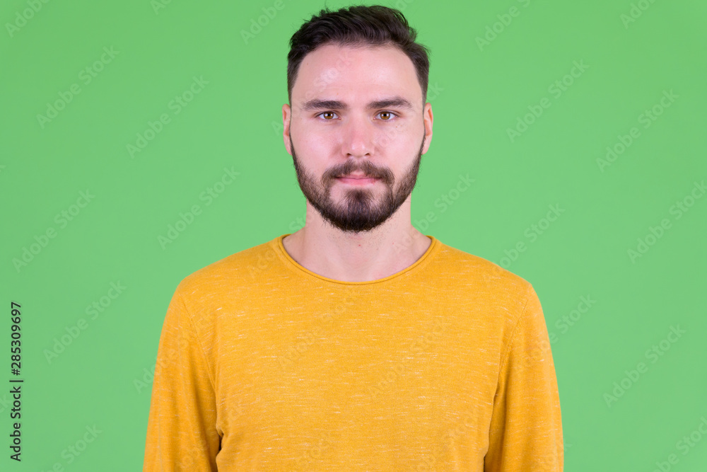 Face of young handsome bearded man looking at camera Face of young handsome bearded man looking at camera