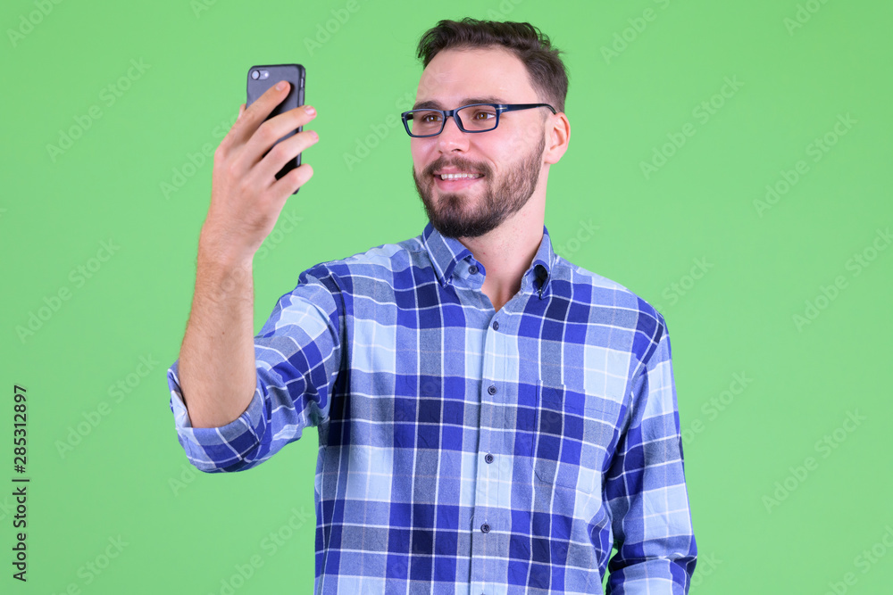 Happy young bearded hipster man taking selfie Happy young bearded hipster man taking selfie
