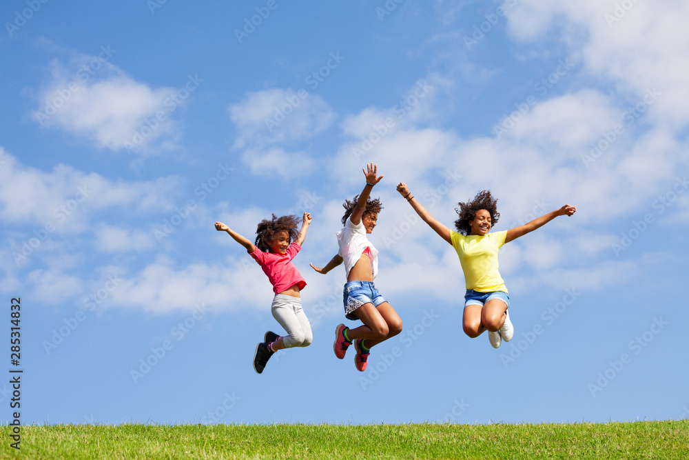 Three cute looking beautiful girls jump over sky Three cute looking beautiful girls jump over sky
