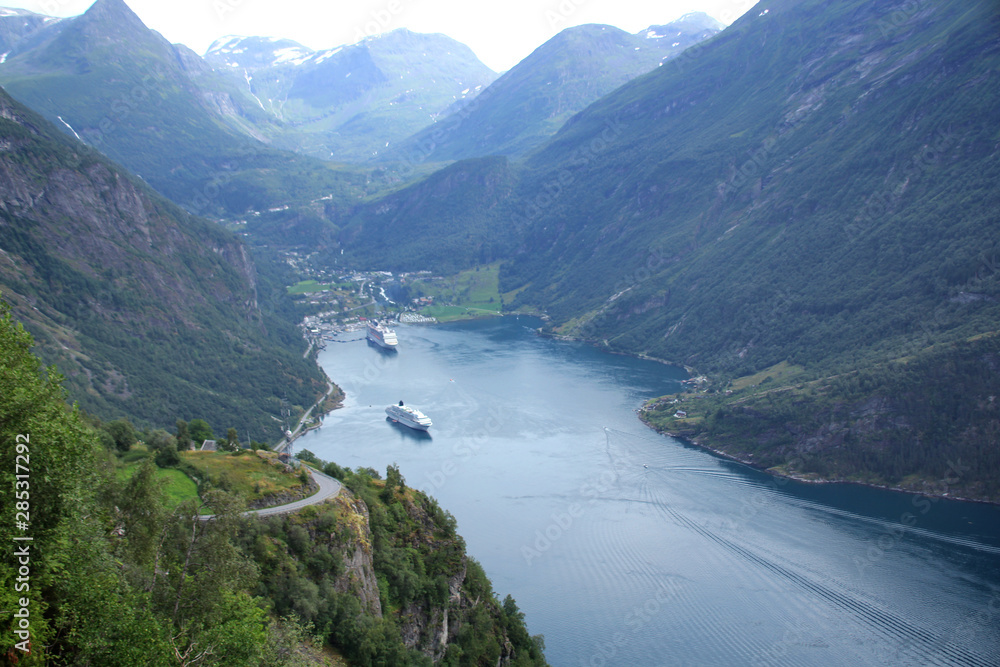beautiful white water liners sail through a narrow fjord in Norway