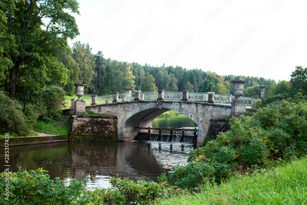 old vintage bridge on river in green park, landscape historical