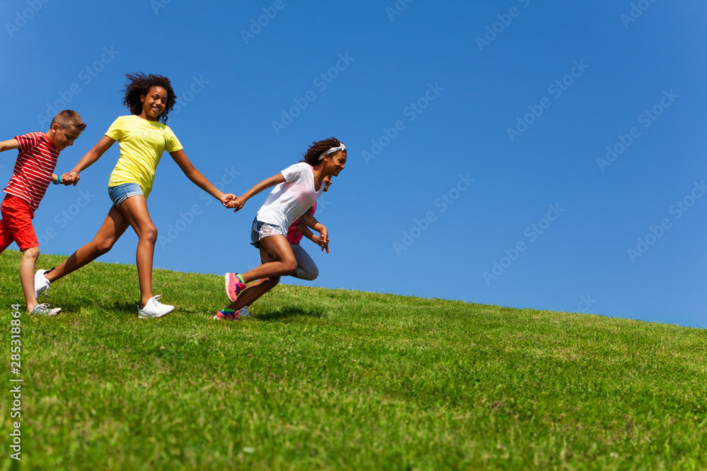 Diverse group of happy fast running children Diverse group of happy fast running children