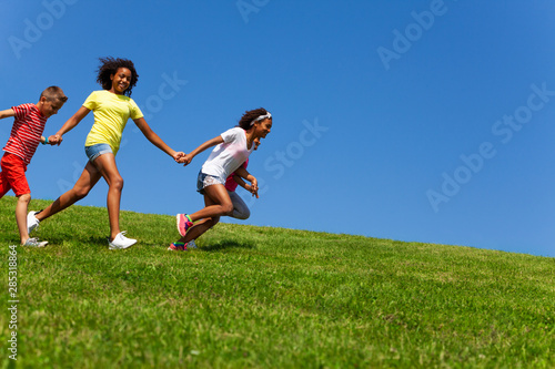 Diverse group of happy fast running children