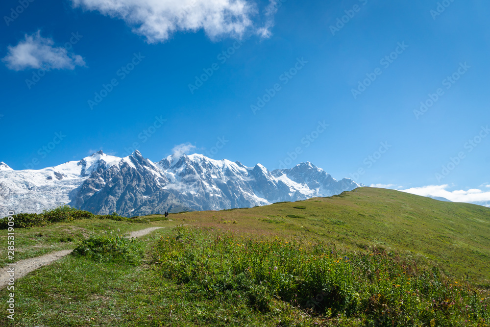 Fototapeta premium Svaneti landscape with glacier and snow-capped mountain in the back near Mestia village in Svaneti region, Georgia.
