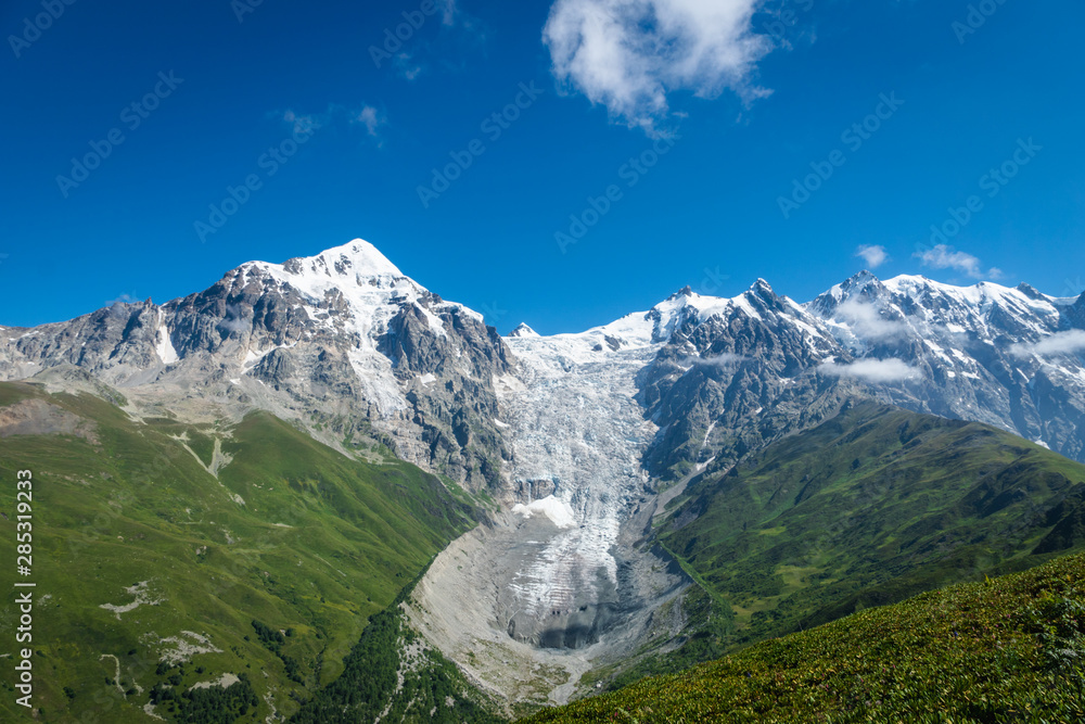 Svaneti landscape with glacier and snow-capped mountain in the back near Mestia village in Svaneti region, Georgia.