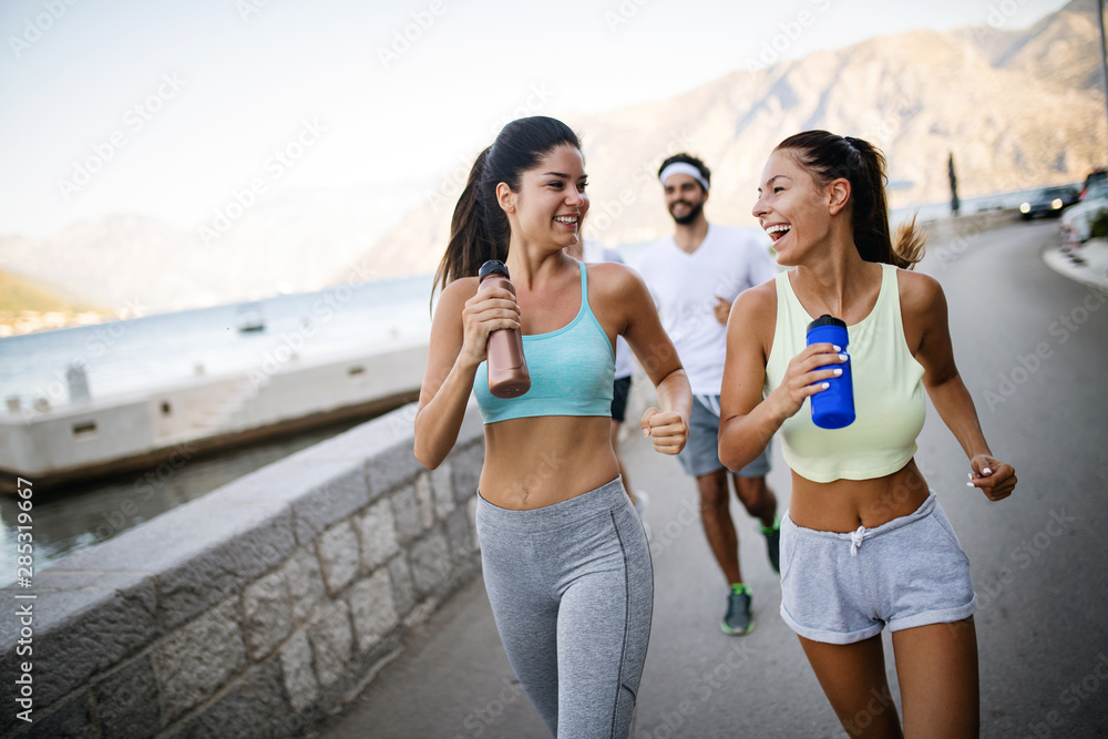 Outdoor portrait of group of friends running and jogging in nature Outdoor portrait of group of friends running and jogging in nature