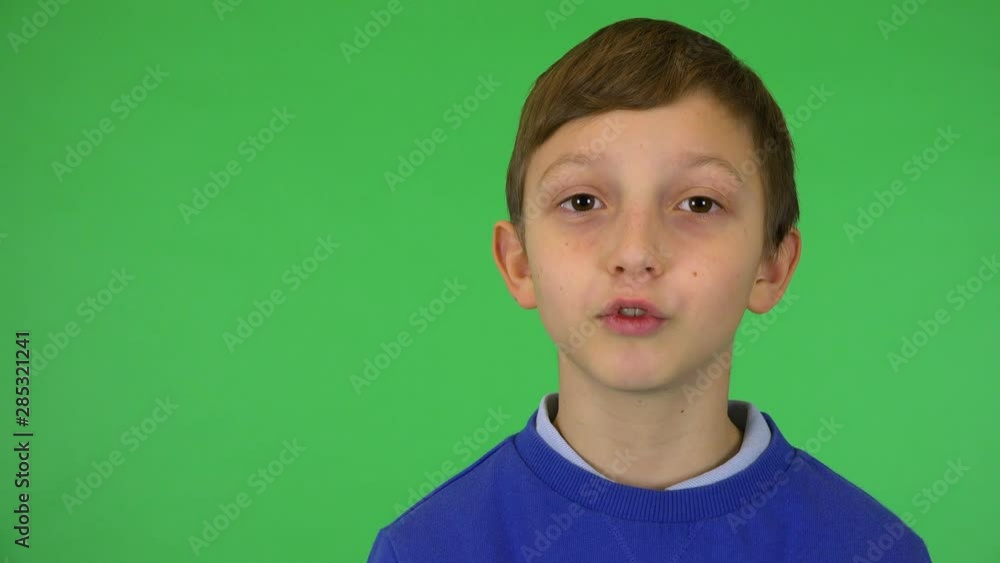 A young cute boy talks to the camera - closeup - green screen studio A young cute boy talks to the camera - closeup - green screen studio