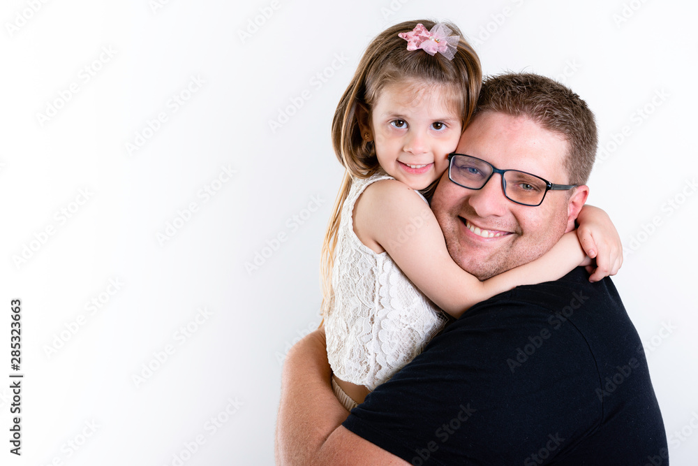 Father's day. Happy family daughter hugging dad and laughs on holiday. White Background, copy space. Father's day. Happy family daughter hugging dad and laughs on holiday. White Background, copy space.