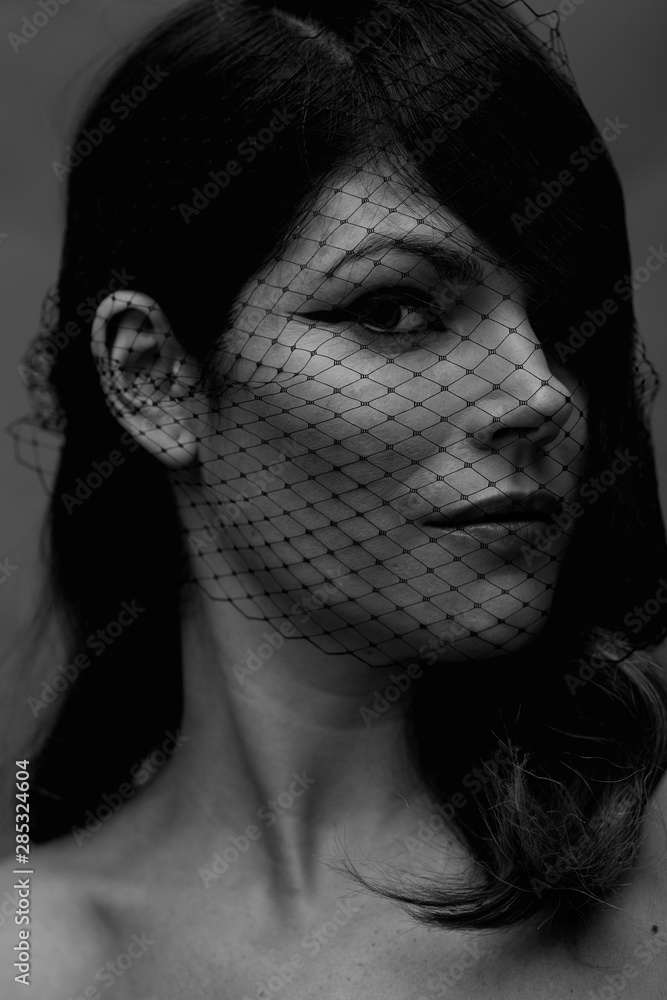 Creative fashion portrait with net over the face Creative fashion portrait with net over the face