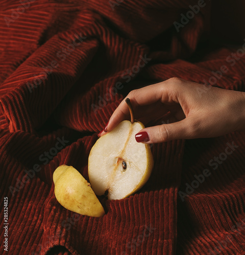 A Woman's Hand Holding a Pear photo