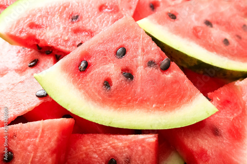 Close-up of fresh red watermelon slices, as background. Summertime concept and vegan healthy food concept.