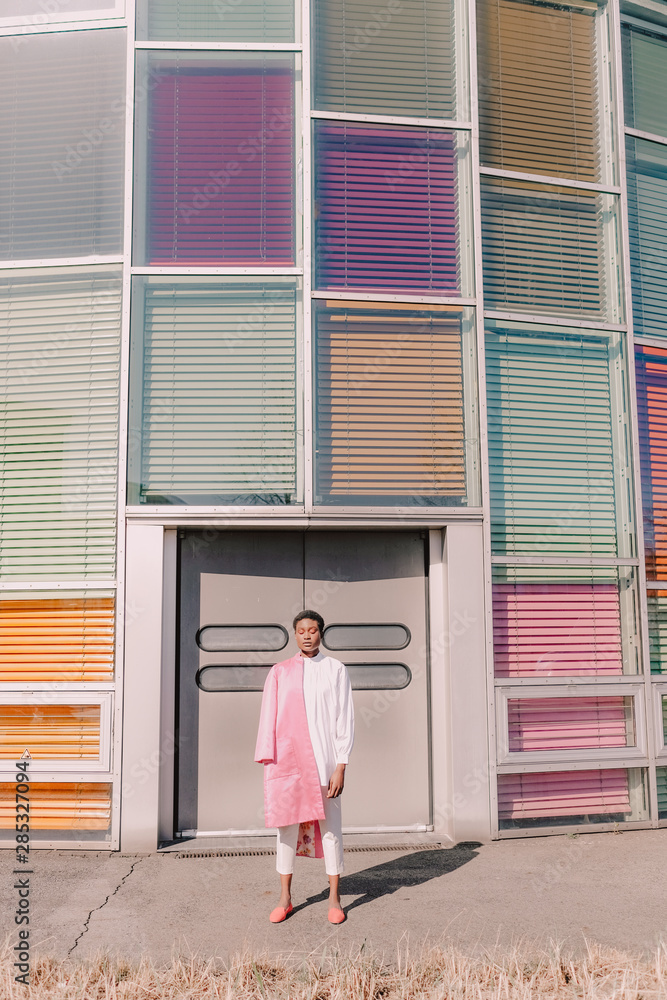 Girl poses with colorful modern building Girl poses with colorful modern building
