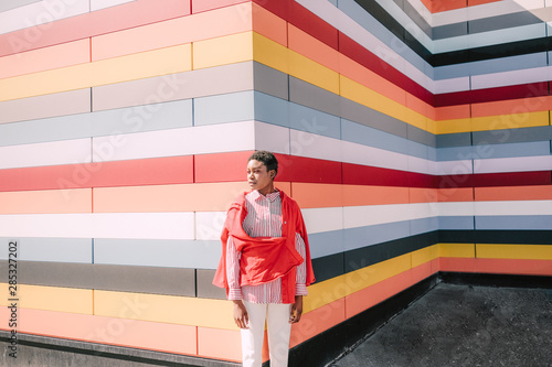 Girl with colorful striped building photo