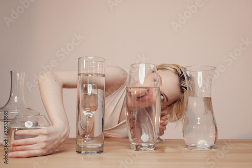 Sensual woman with glassware full of water photo