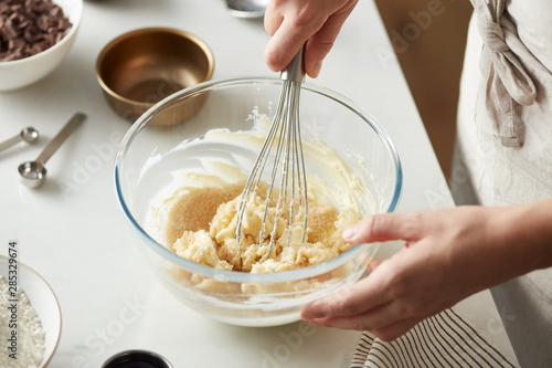 Cook preparing dough for cookies.