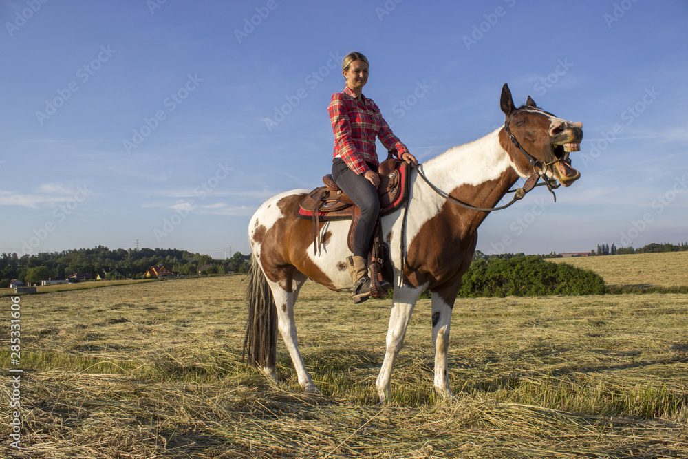 Young girl and laughing horse