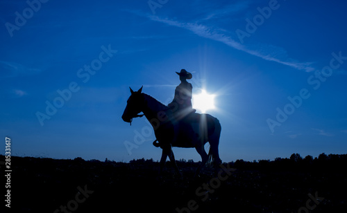 Silhouette cowgirl on horse at sunset in blue (8)