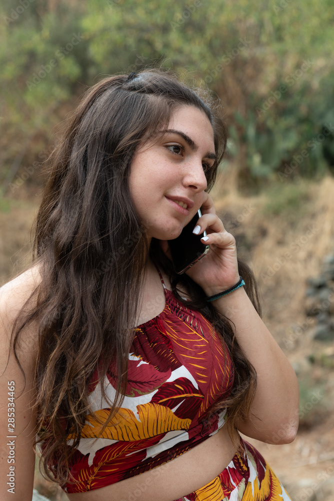 Young teenage girl, holding looking at the smartphone