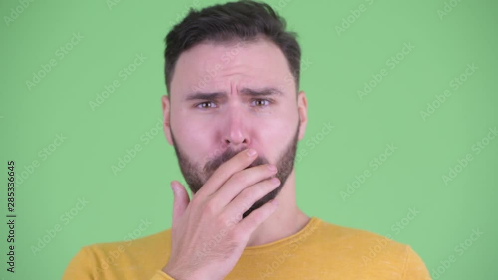 Face of young handsome bearded man looking shocked Face of young handsome bearded man looking shocked