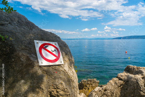 Fototapeta Naklejka Na Ścianę i Meble -  Sunbath is banned in this beach at the Adriatic sea