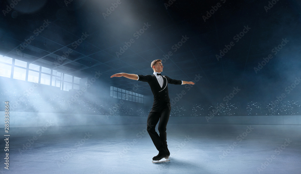 Figure skating couple in professional ice arena.