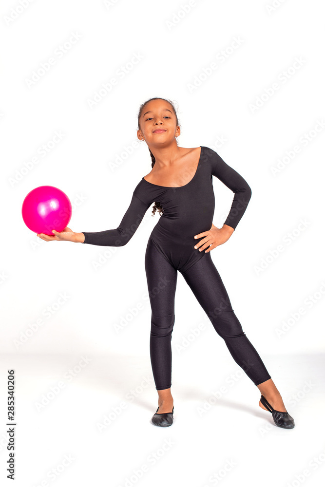 Φωτογραφία Attractive little  gymnast girl of  with a pink ball on a white background, full length