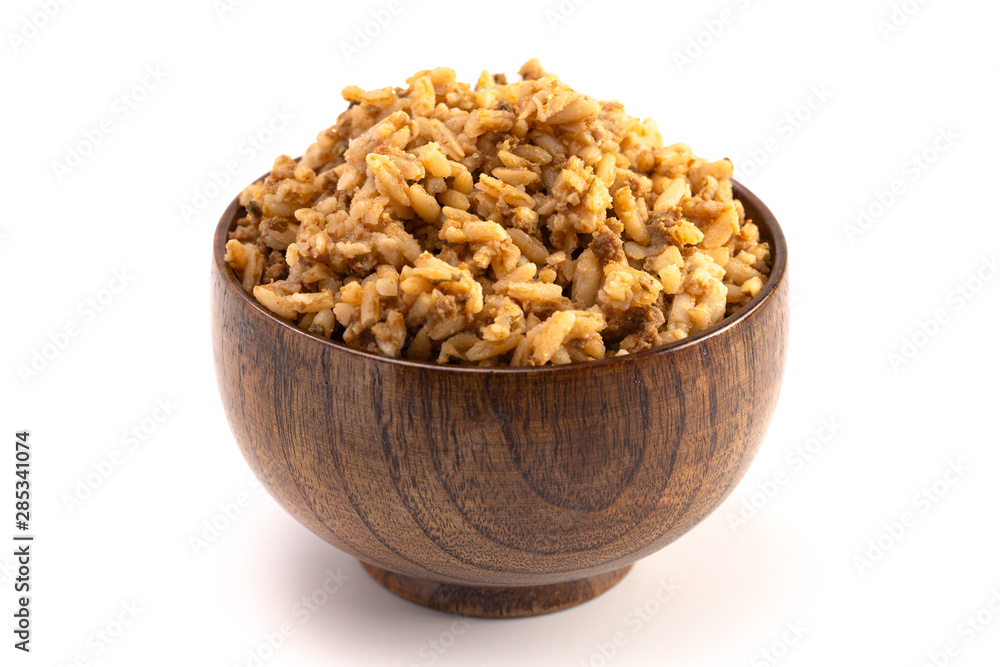 Cajun Dirty Rice in a Wooden Bowl on a White Background Cajun Dirty Rice in a Wooden Bowl on a White Background