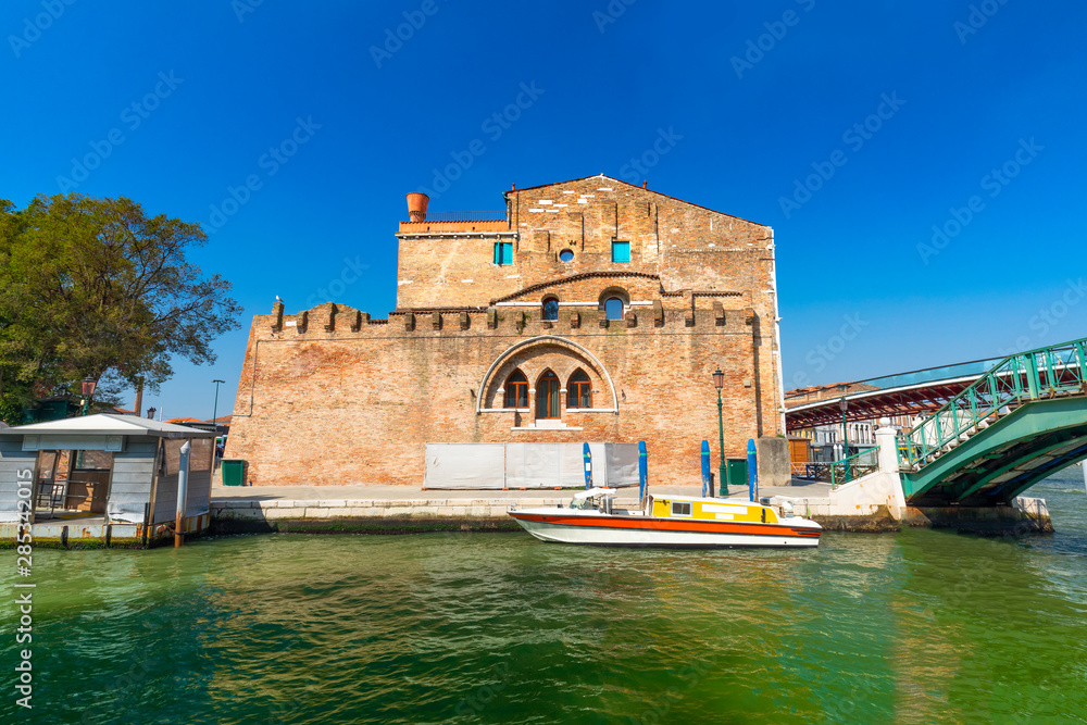 Old Traditional houses and a boat with blue sky backkground Venice Italy.