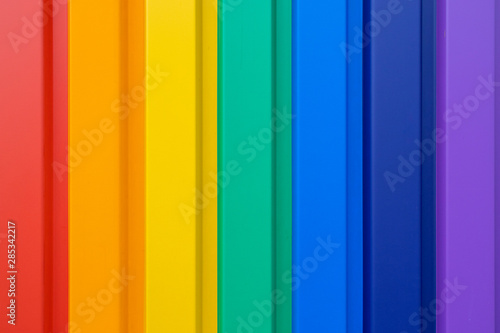 Multiples vertical color stripes on a metal wall - flawlessly painted with lovely vivid colors