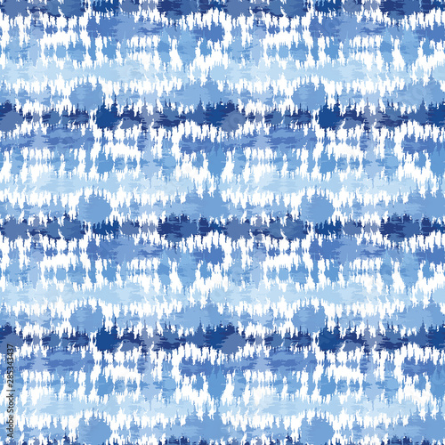 Indigo blue shibori tie dye horizontal stripe. Seamless pattern background. Japanese style batik textile. Variegated for summer fashion swatch.