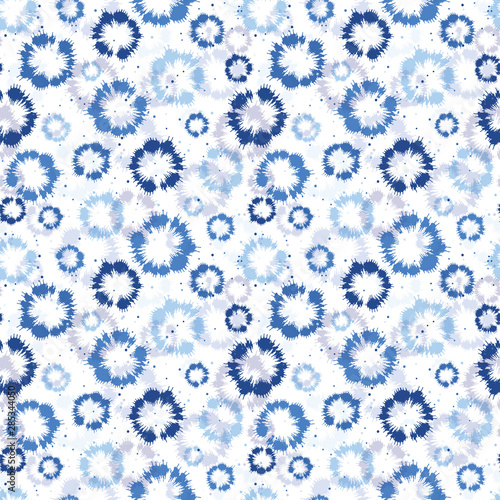 Indigo blue shibori tie dye sunburst circle background. Seamless pattern on white background. Japanese style batik textile. Variegated for summer fashion swatch.