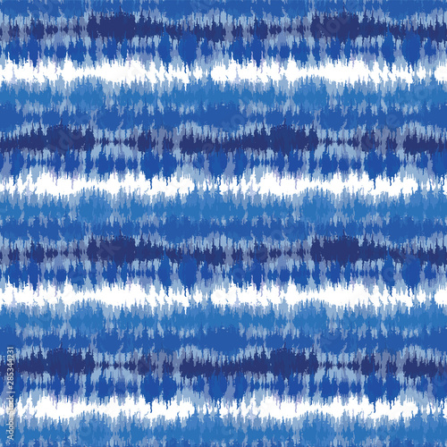 Indigo blue shibori tie dye horizontal stripe. Seamless pattern background. Japanese style batik textile. Variegated for summer fashion swatch.