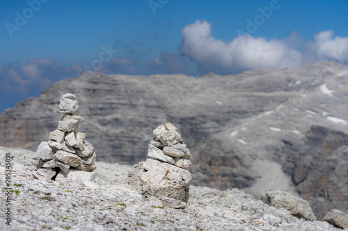 des cairns au milieu des pierres d'un sommet désert sur fond bleu © Olivier Tabary