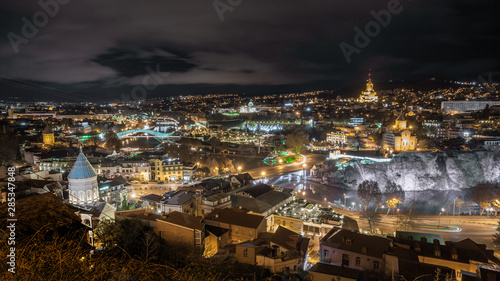 Night view of Tbilisi with Sameba (Trinity) Church and other landmarks. Travel.