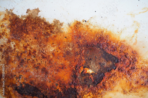 Rust and dirt on white enamel. Rusted brown and white abstract texture. Corroded white metal background. Rusted white painted metal wall. Rusty metal surface with streaks of rust.  © olympuscat