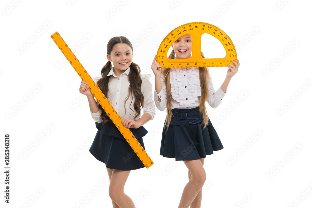 Geometry lesson is much fun. Little girls holding protractor and ruler for lesson. Small children with measuring instruments at school lesson. Cute schoolgirls preparing for geometry lesson Geometry lesson is much fun. Little girls holding protractor and ruler for lesson. Small children with measuring instruments at school lesson. Cute schoolgirls preparing for geometry lesson