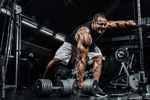 Hard Core Bodybuilding. Bodybuilder ready to lift heavy dumbbell © mrbigphoto