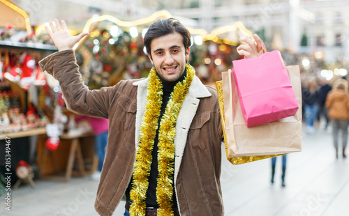 Man expression happinnes from buying decoration at Christmas fair photo