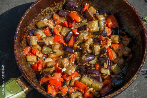 fried or fried eggplant, carrots, bell peppers, onions in a pan