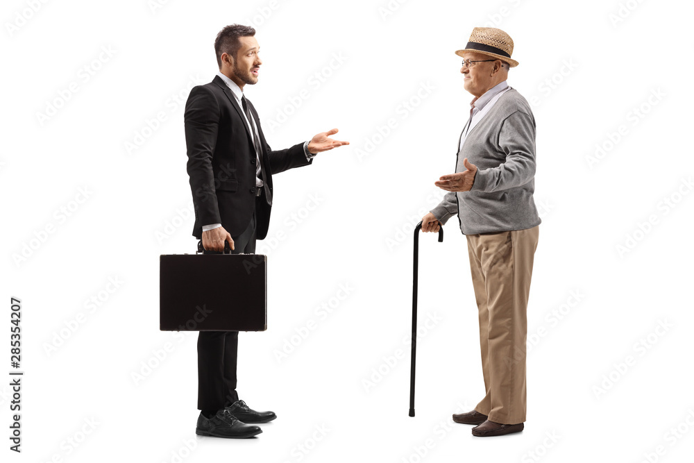 Businessman with a suitcase having a conversation with an elderly gentleman Businessman with a suitcase having a conversation with an elderly gentleman