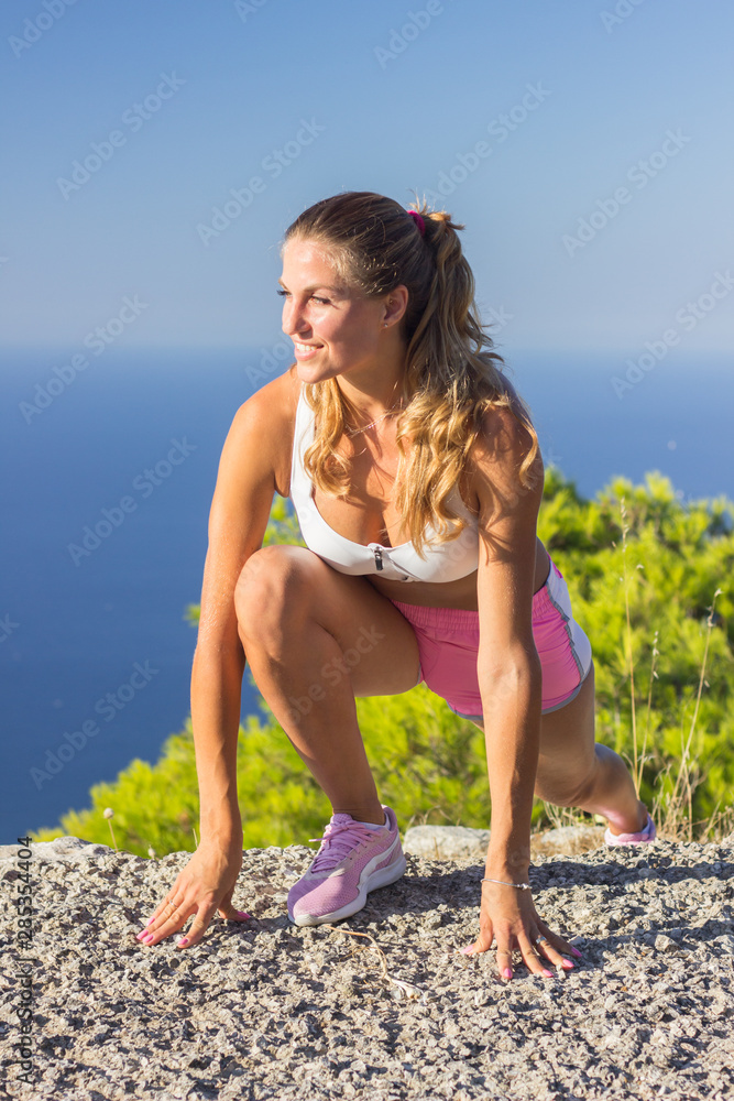 Young woman workout outdoors summer day sea Young woman workout outdoors summer day sea
