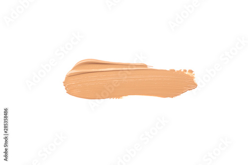 Bright beige smear of foundation in the form of a group of horizontal strokes isolated on a white background.