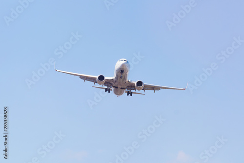 Passenger airplane landing in the airport runway. Passenger plane and blue sky with clouds. Details of airplane landing .