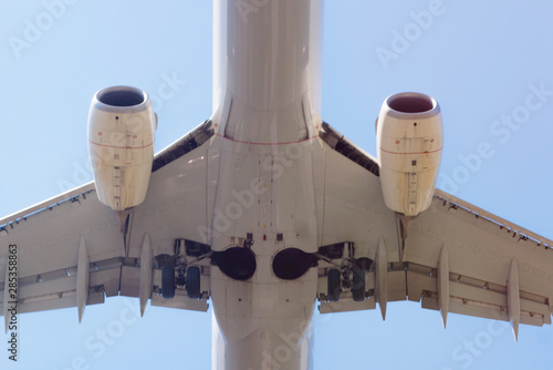 Passenger airplane landing in the airport runway. Passenger plane and blue sky with clouds. Details of airplane landing . photo